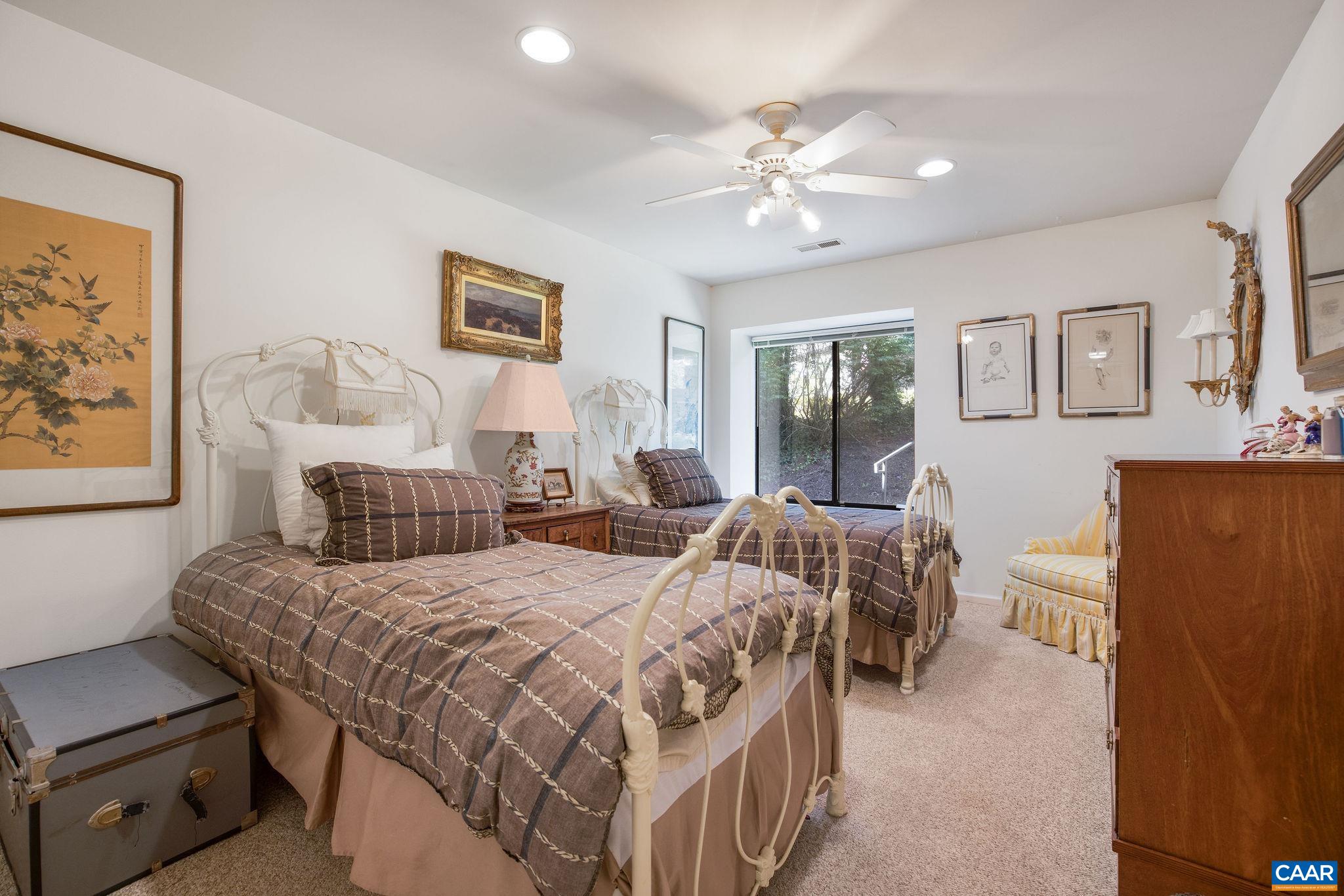 1249 Timberbranch Court Charlottesville, VA 22902 - Photo 18 of 34 a bedroom with a bed and a chandelier