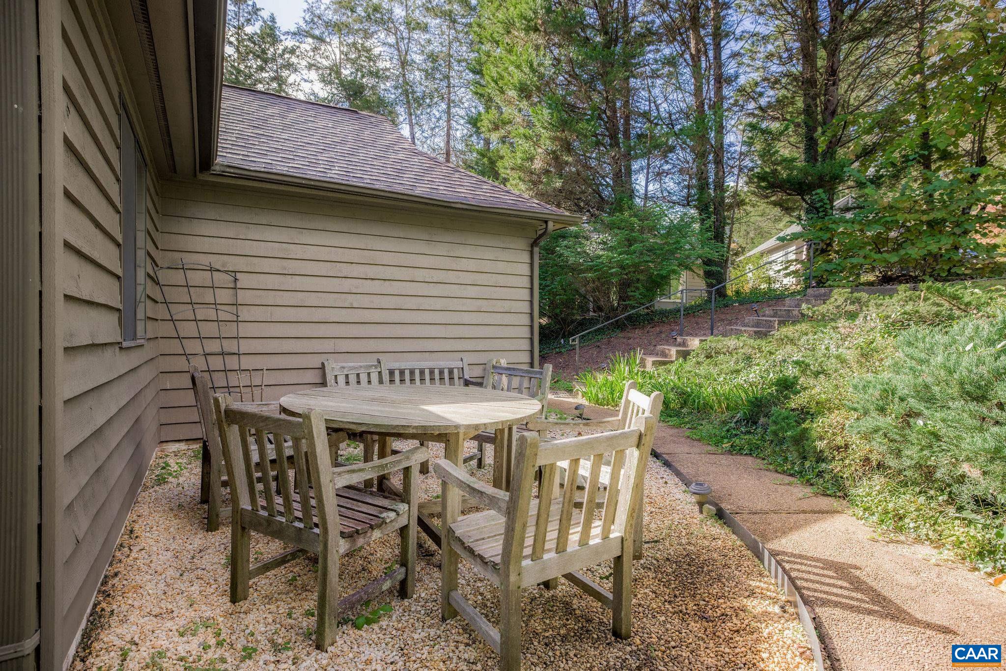 1249 Timberbranch Court Charlottesville, VA 22902 - Photo 29 of 34 a view of a patio with table and chairs a barbeque with wooden fence and plants