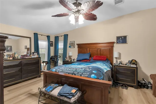 a bedroom with a bed and a chandelier