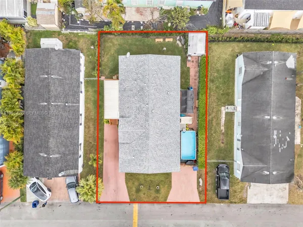 an aerial view of a house with a swimming pool outdoor seating