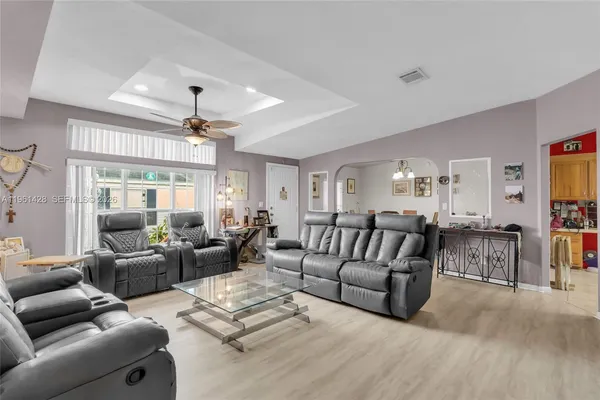 a living room with furniture and a chandelier