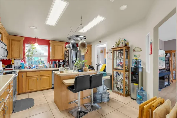 a kitchen with stainless steel appliances kitchen island granite countertop a sink and cabinets