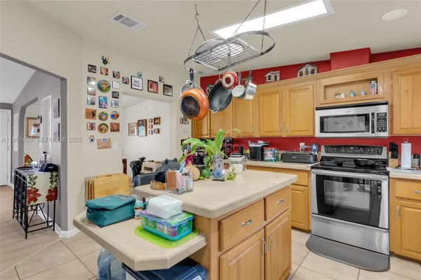 a kitchen with kitchen island stainless steel appliances a stove a sink and a refrigerator