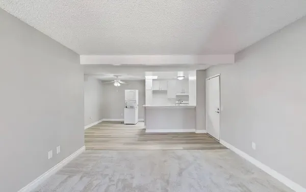 an empty room with a fireplace and windows