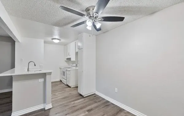 a view of a kitchen with wooden floor and a sink