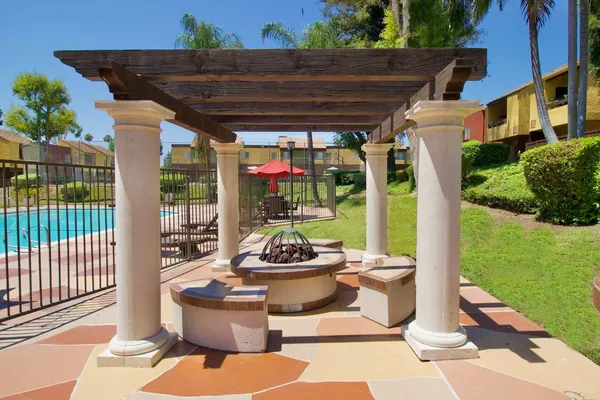 a small swimming pool with outdoor seating