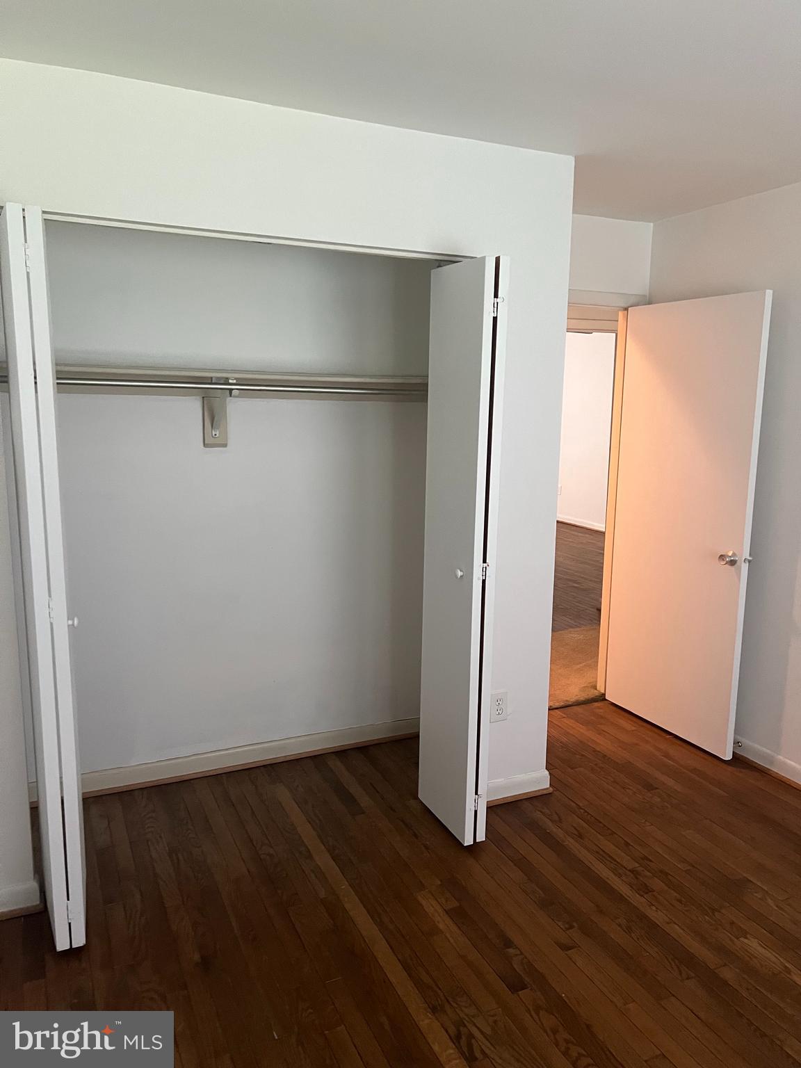 2040 Golf Course Drive Reston, VA 20191 - Photo 16 of 34 a view of an empty room with wooden floor and closet