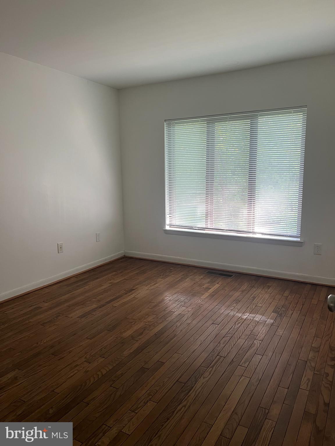 2040 Golf Course Drive Reston, VA 20191 - Photo 17 of 34 an empty room with wooden floor and windows