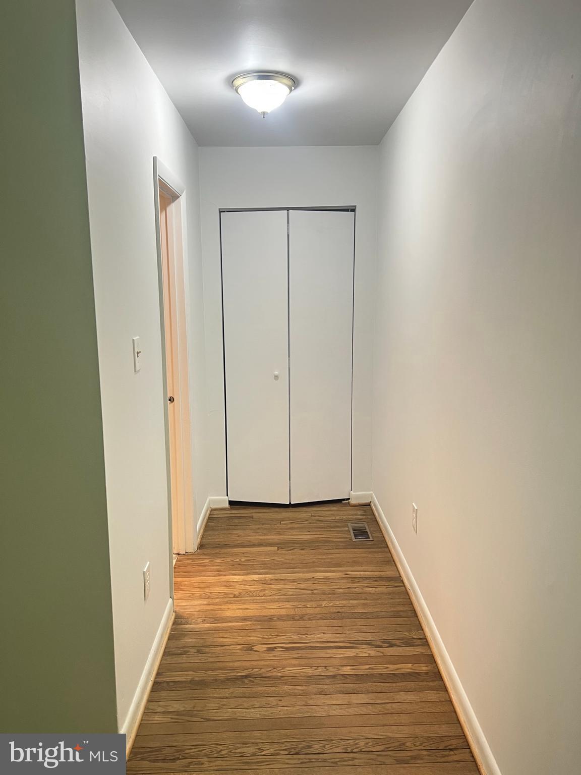 2040 Golf Course Drive Reston, VA 20191 - Photo 21 of 34 a view of a hallway with wooden floor