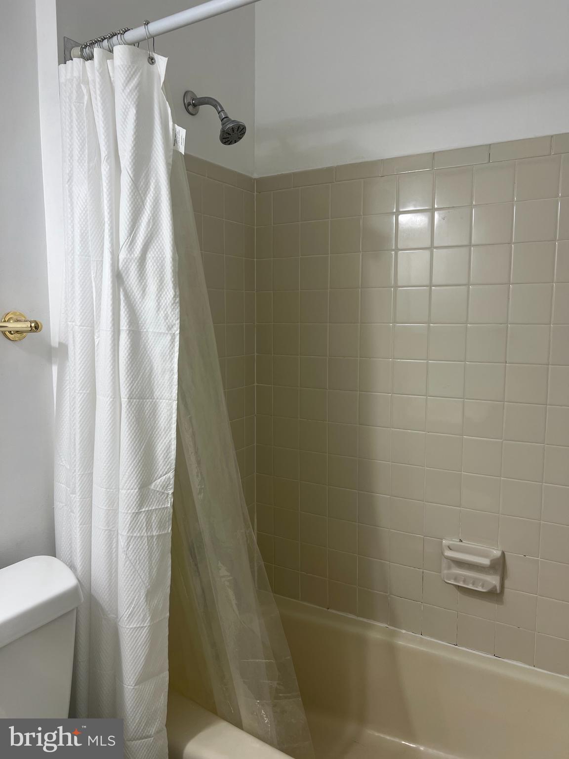 2040 Golf Course Drive Reston, VA 20191 - Photo 24 of 34 a bathroom with a shower curtain and a toilet