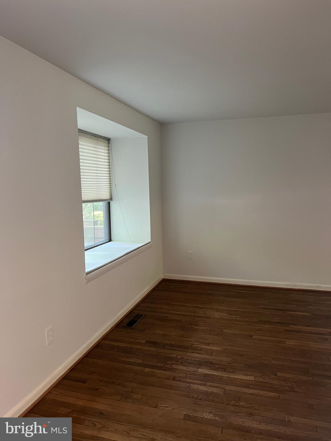 2040 Golf Course Drive Reston, VA 20191 - Photo 3 of 34 a view of an empty room with wooden floor and a window