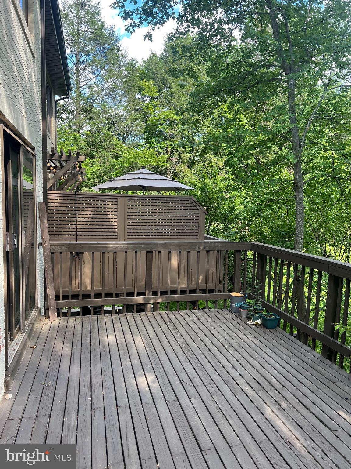 2040 Golf Course Drive Reston, VA 20191 - Photo 32 of 34 a balcony with wooden floor and yard in the back