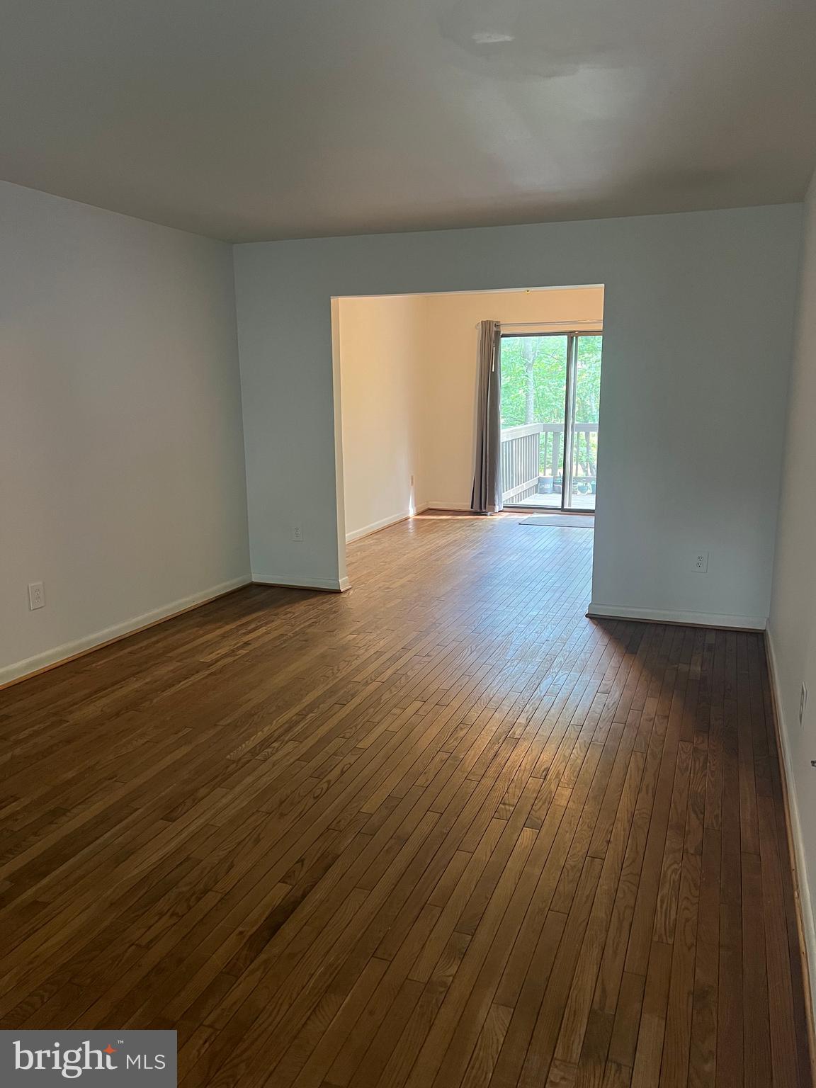2040 Golf Course Drive Reston, VA 20191 - Photo 4 of 34 a view of an empty room with wooden floor and a window