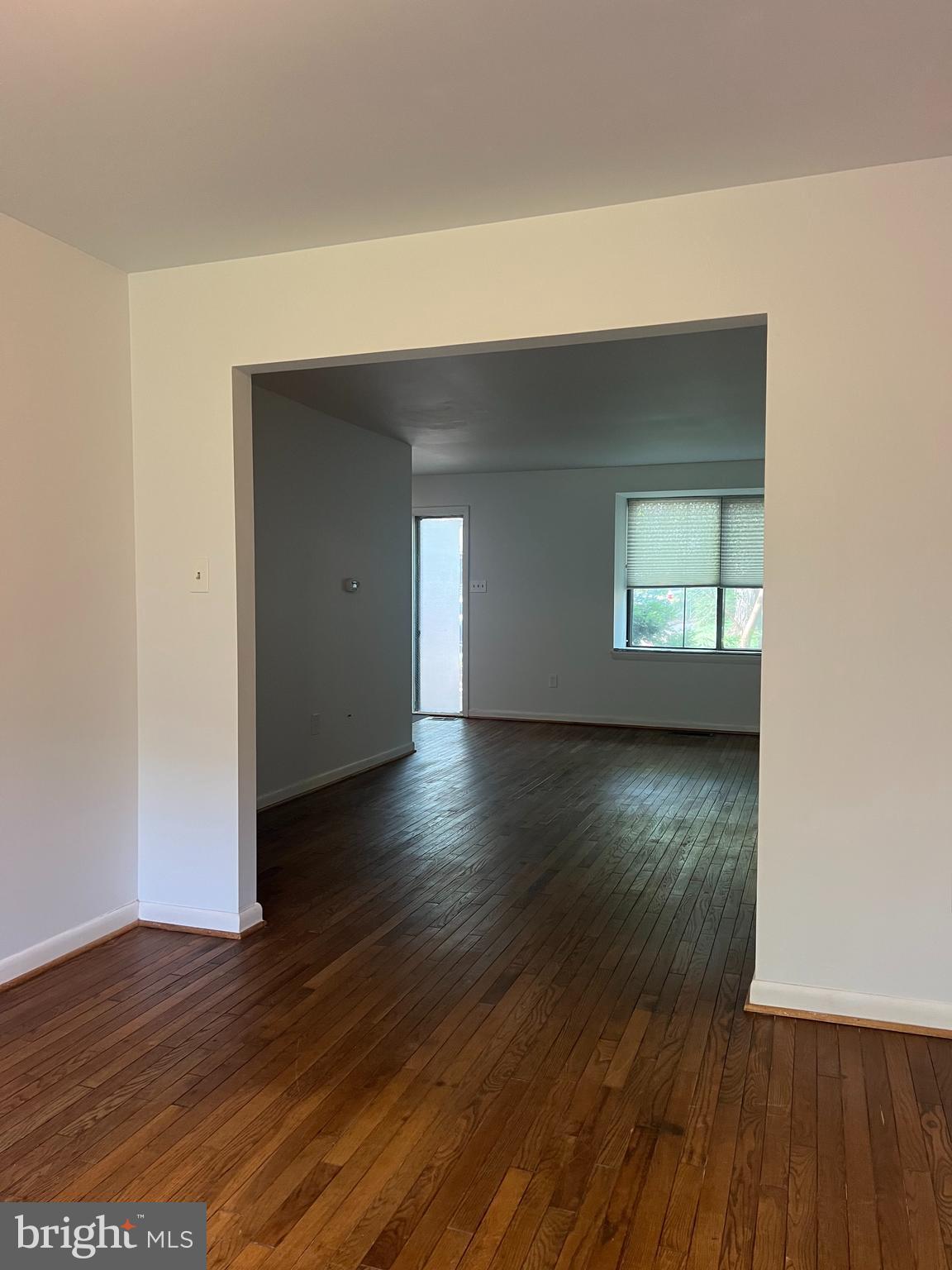 2040 Golf Course Drive Reston, VA 20191 - Photo 6 of 34 an empty room with wooden floor and windows