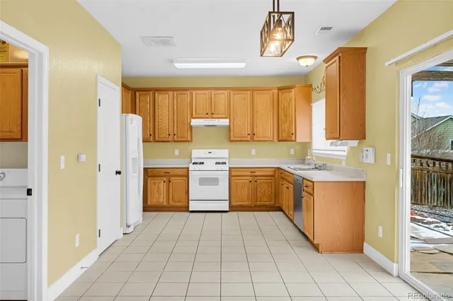 a kitchen with a stove a sink and a refrigerator