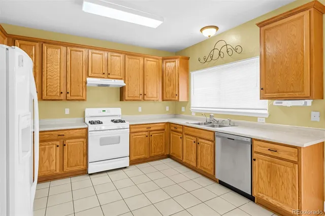 a kitchen with a stove sink and cabinets