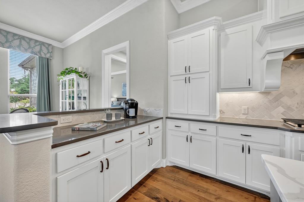 6656 Roughleaf Ridge Road Flower Mound, TX 76226 - Photo 13 of 40 a kitchen with granite countertop white cabinets and a sink