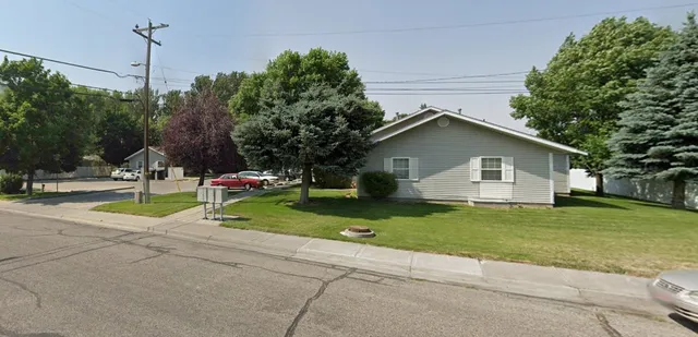a backyard of a house with barbeque oven table and chairs