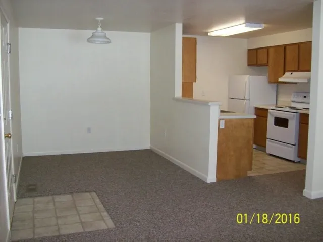 a kitchen with a refrigerator and a stove top oven