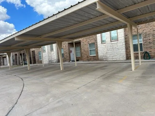 a kitchen with granite countertop a refrigerator stove and cabinets