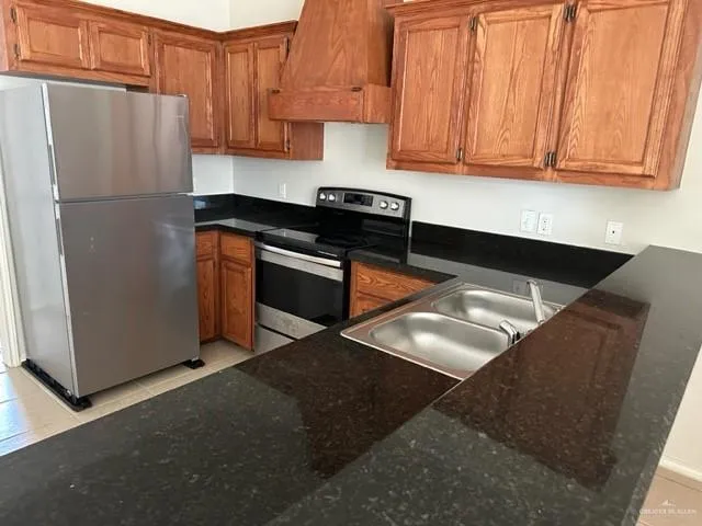 a kitchen with stainless steel appliances granite countertop a stove and a sink