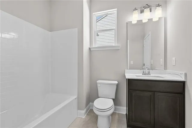 a view of a hallway with wooden floor and a kitchen