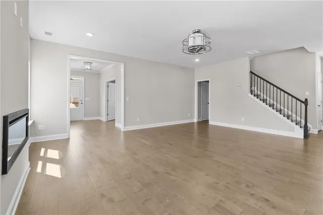 a large kitchen with kitchen island a large counter top stainless steel appliances and cabinets