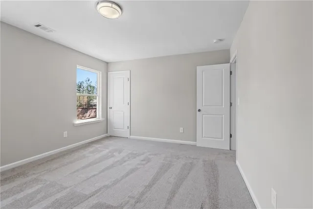 a view of an empty room with windows