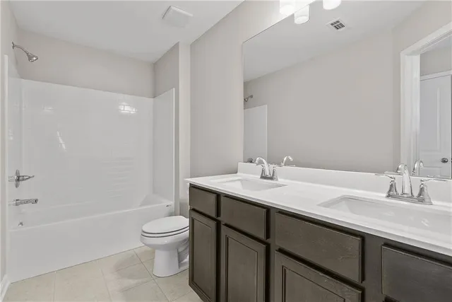 a view of a big room with a chandelier fan and windows