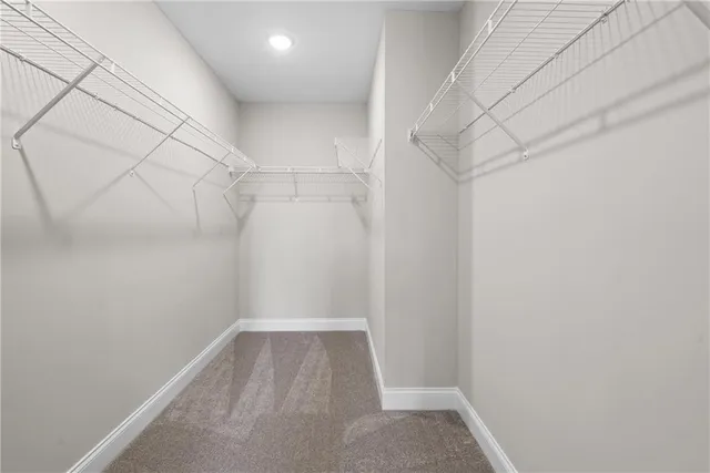 a spacious bathroom with a granite countertop sink and a bathtub