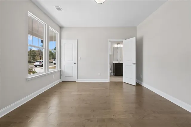 an empty room with windows and closet