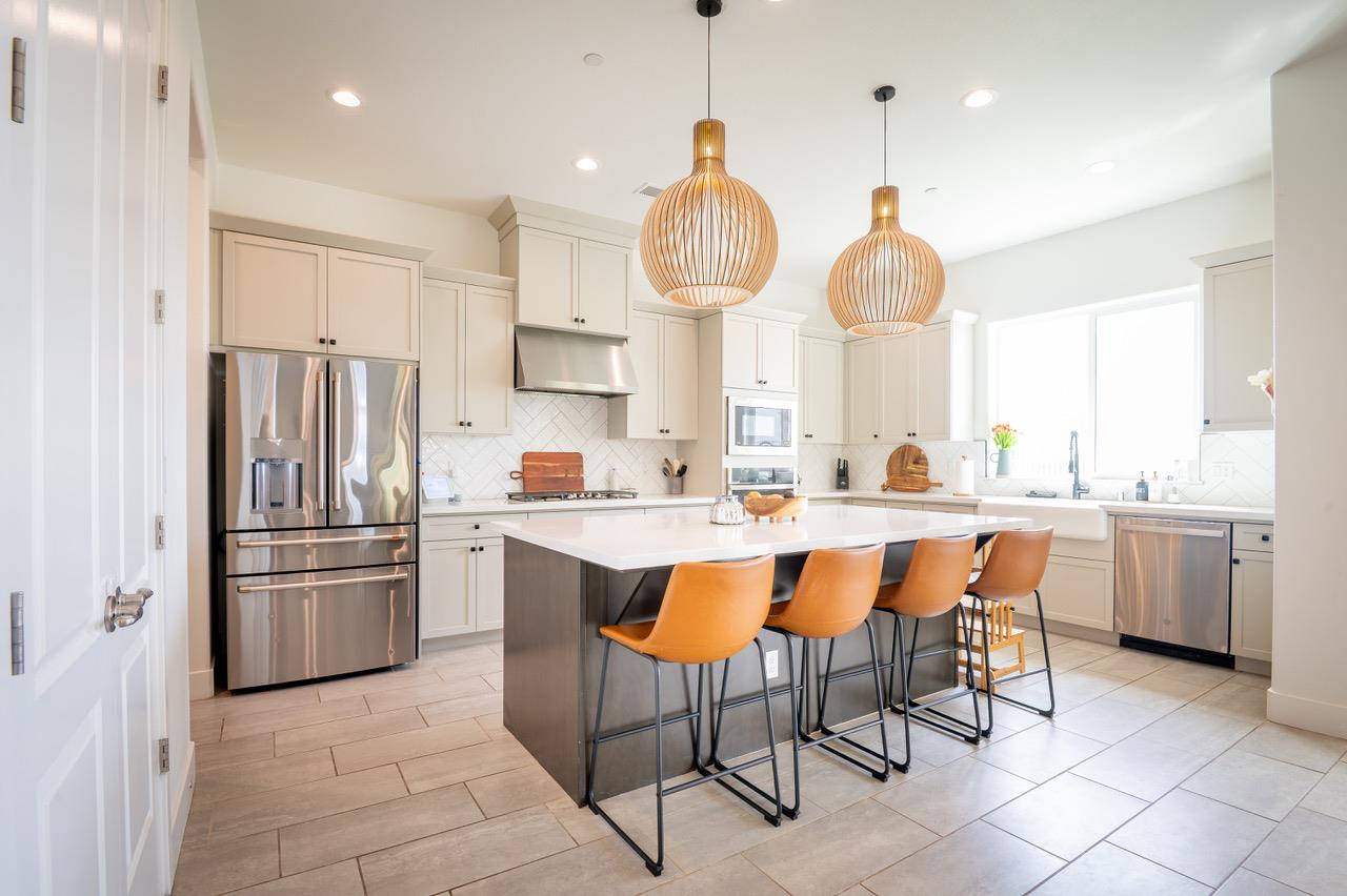 1048 Beaver Pond Loop Madera, CA 93636 - Photo 4 of 27 a large kitchen with a table and chairs