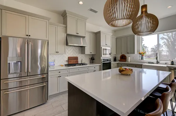 a bedroom with a bed chair and a large window
