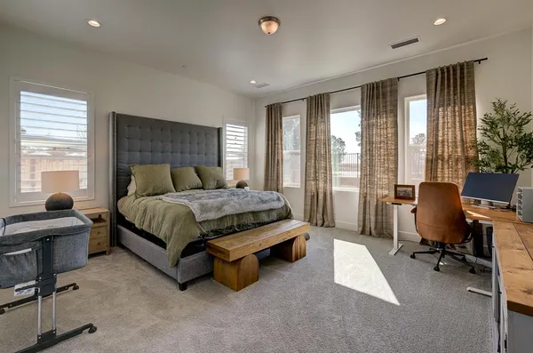 a bedroom with furniture and a window