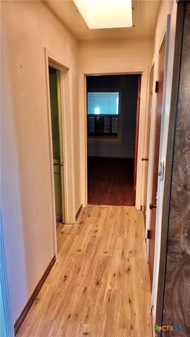 a view of an empty room and a window