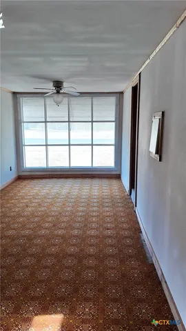 a view of room with window and hardwood floor