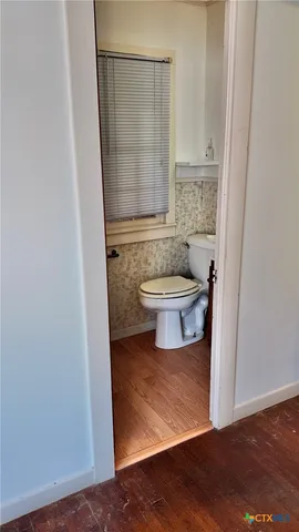 a bathroom with a toilet and a sink