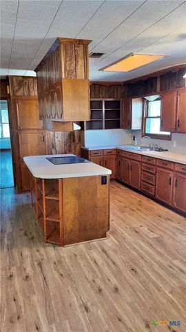 a kitchen with stainless steel appliances granite countertop a sink a stove counter space and cabinets