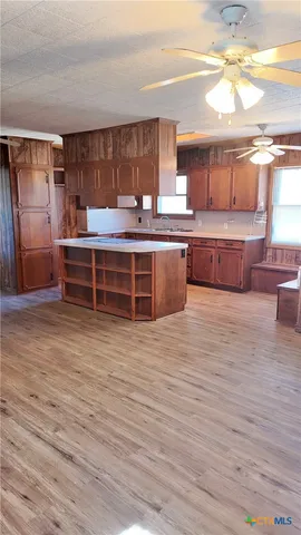 a kitchen with stainless steel appliances wooden cabinets and a counter top space