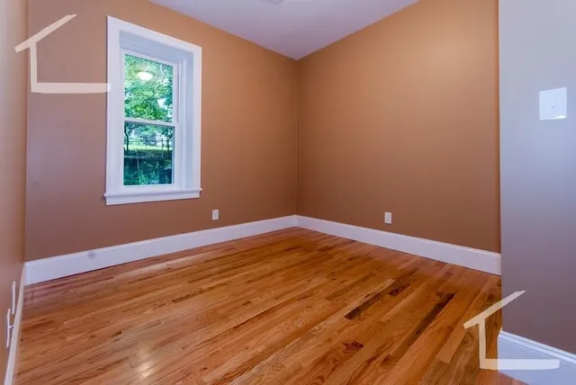 a view of a room with wooden floor and fan