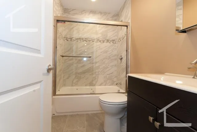 a bathroom with a toilet a sink and shower