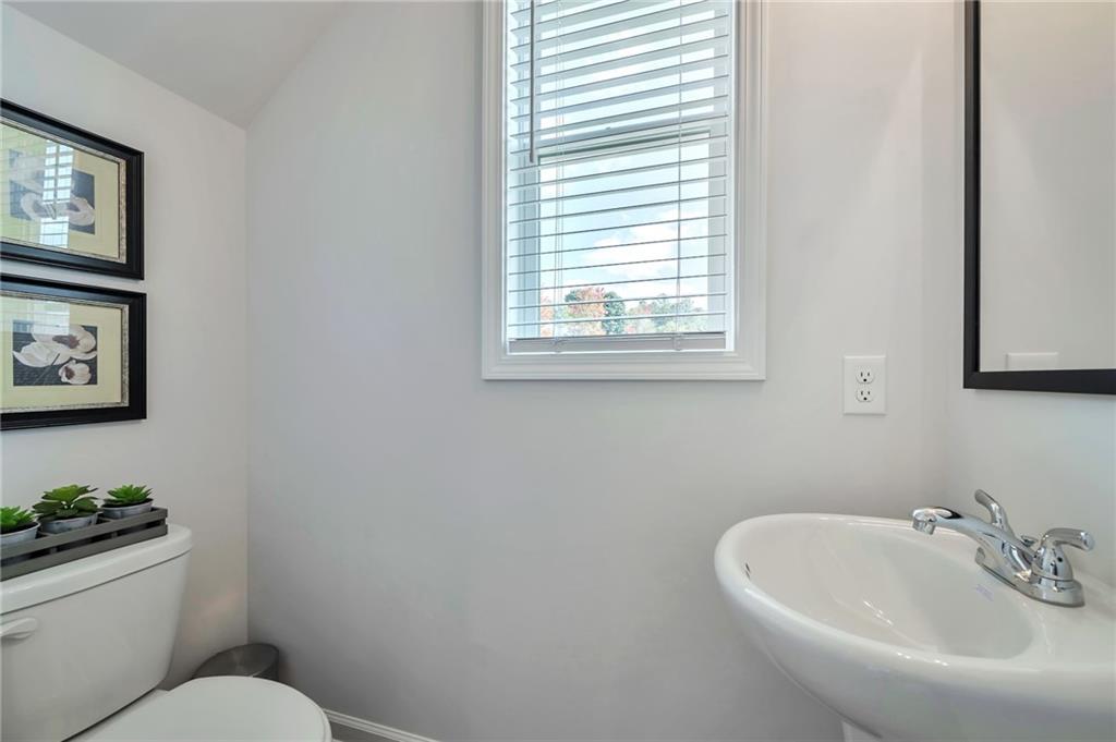 104 Windmill Court Calhoun, GA 30701 - Photo 11 of 23 a bathroom with a sink mirror and toilet