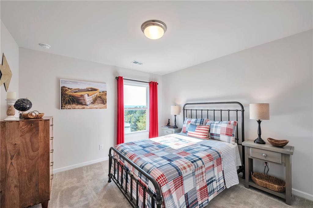 104 Windmill Court Calhoun, GA 30701 - Photo 16 of 23 a bedroom with a balcony a bed and a dresser next to a window