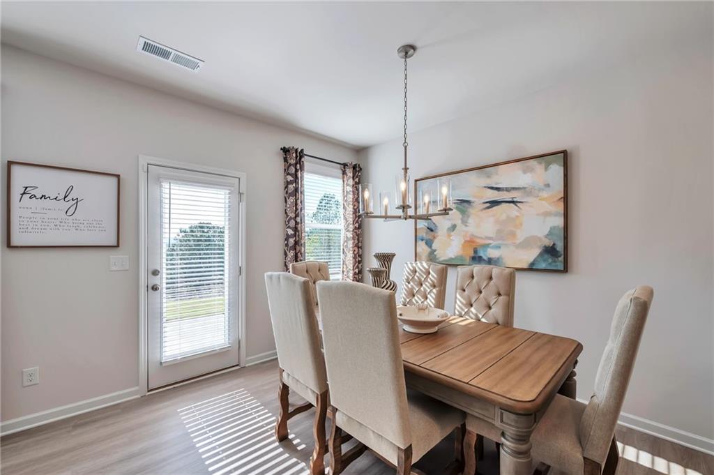 104 Windmill Court Calhoun, GA 30701 - Photo 6 of 23 a view of a dining room with furniture window and wooden floor