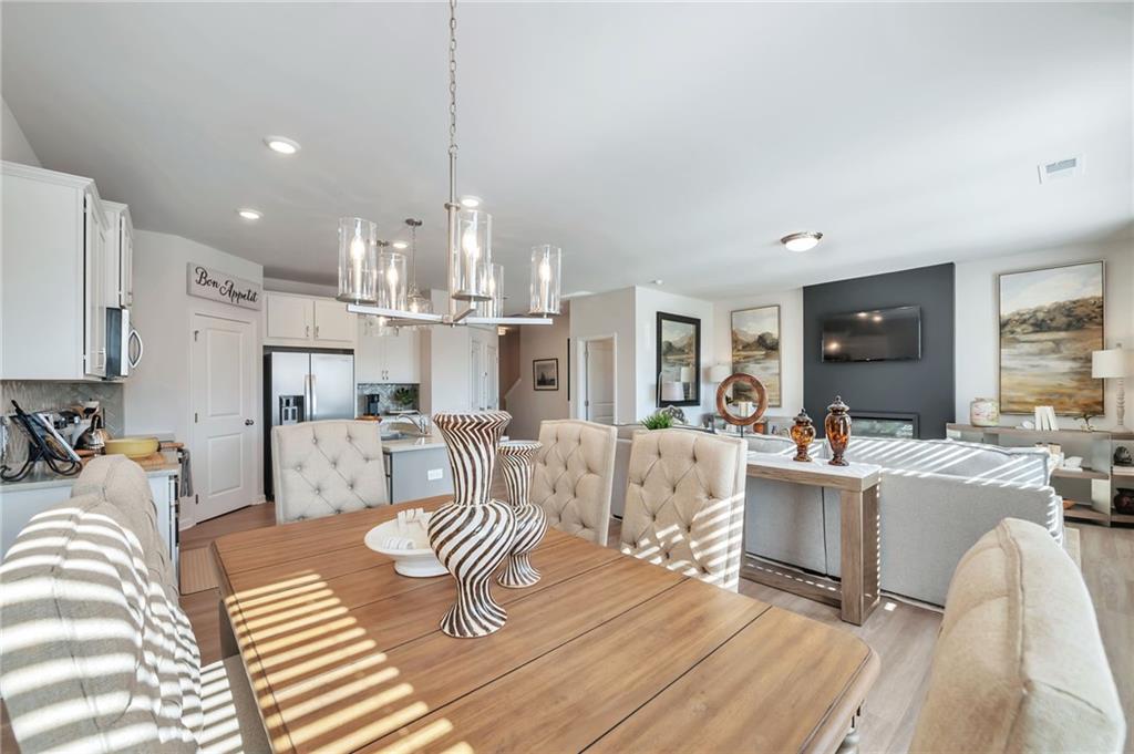 104 Windmill Court Calhoun, GA 30701 - Photo 8 of 23 a living room with furniture and a chandelier