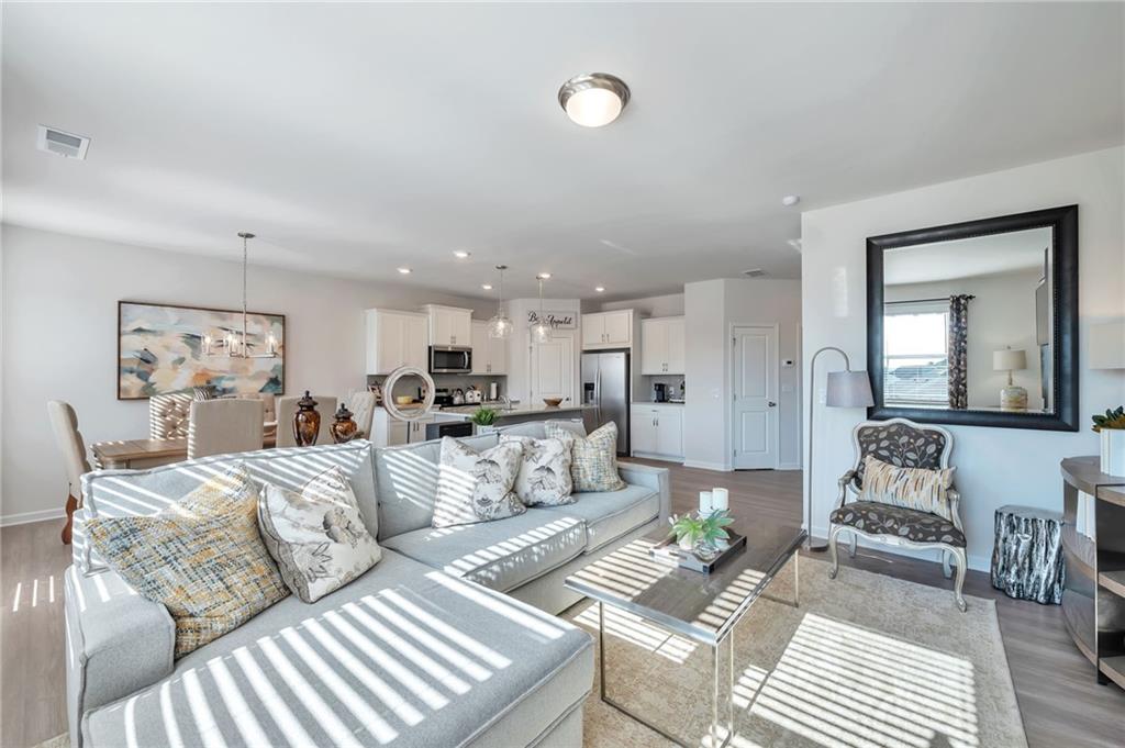104 Windmill Court Calhoun, GA 30701 - Photo 10 of 23 a living room with furniture and a wooden floor
