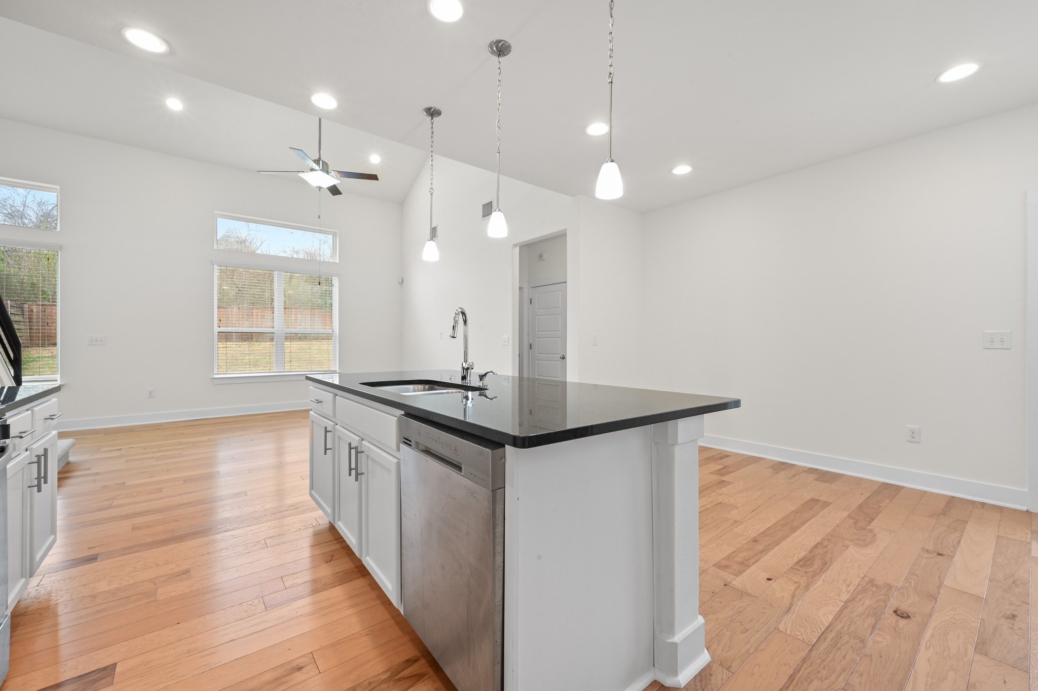 2204 Theseus Pass Austin, TX 78741 - Photo 13 of 31 a kitchen with stainless steel appliances granite countertop a sink a stove and a wooden floors