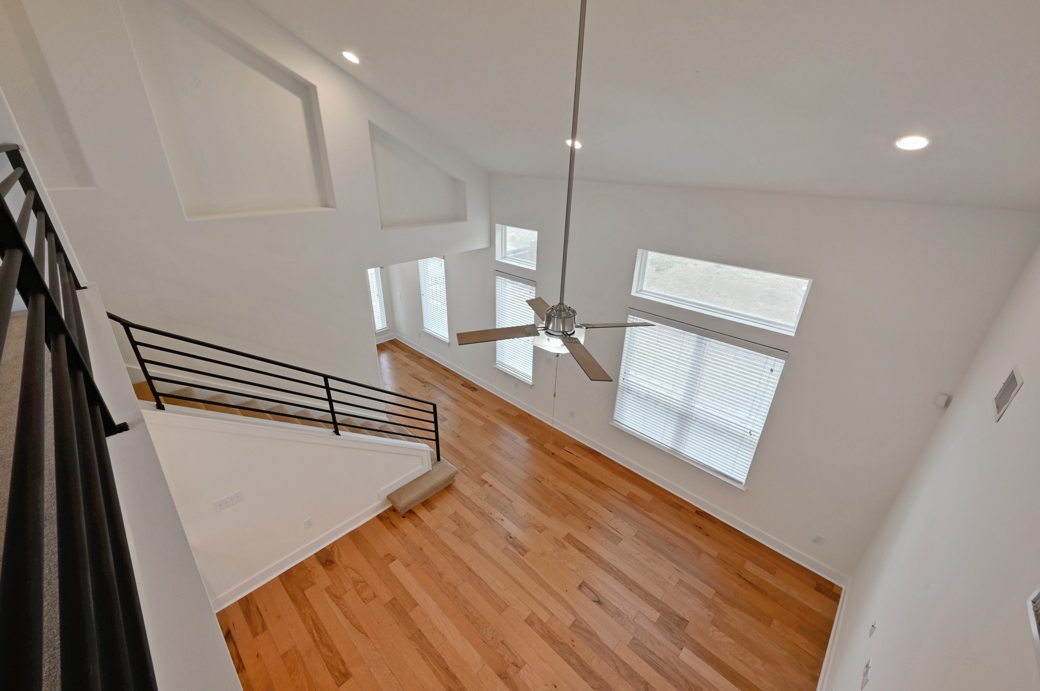 2204 Theseus Pass Austin, TX 78741 - Photo 23 of 31 a view of an empty room with wooden floor and stairs