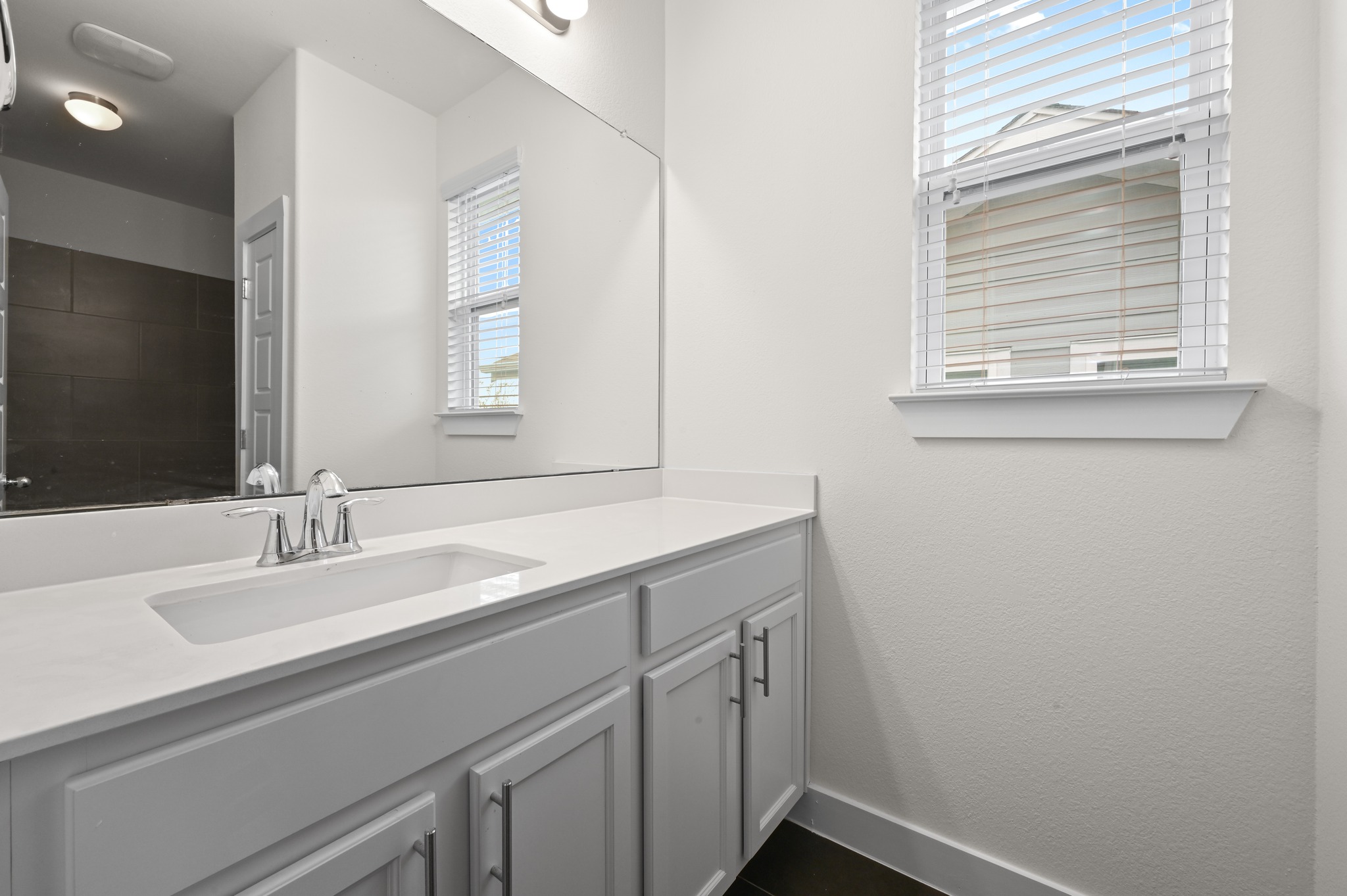 2204 Theseus Pass Austin, TX 78741 - Photo 26 of 31 a bathroom with a sink a vanity and a mirror