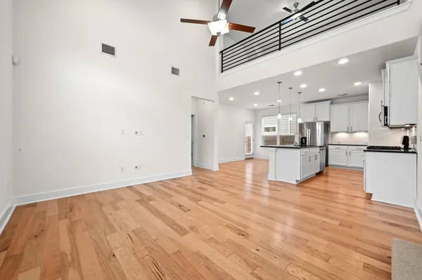 a view of kitchen with kitchen island sink and refrigerator